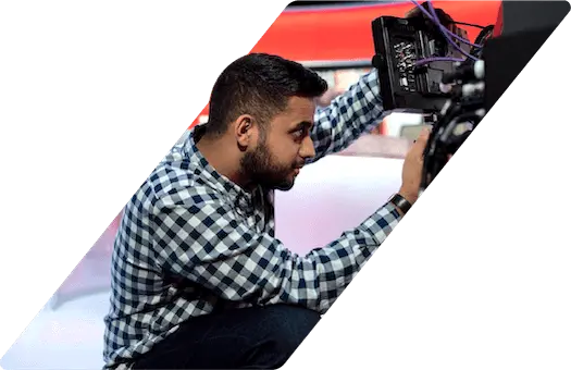 An audio visual technician adjusting equipment