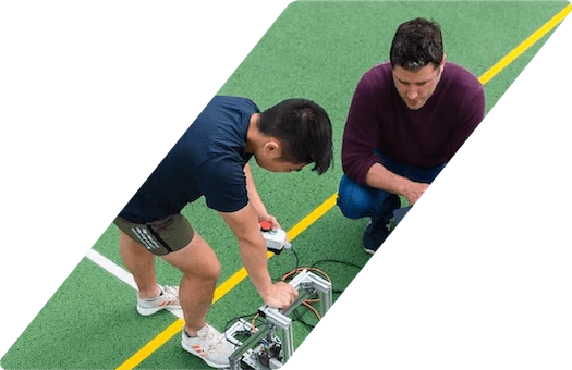 Engineers making adjustments to a device