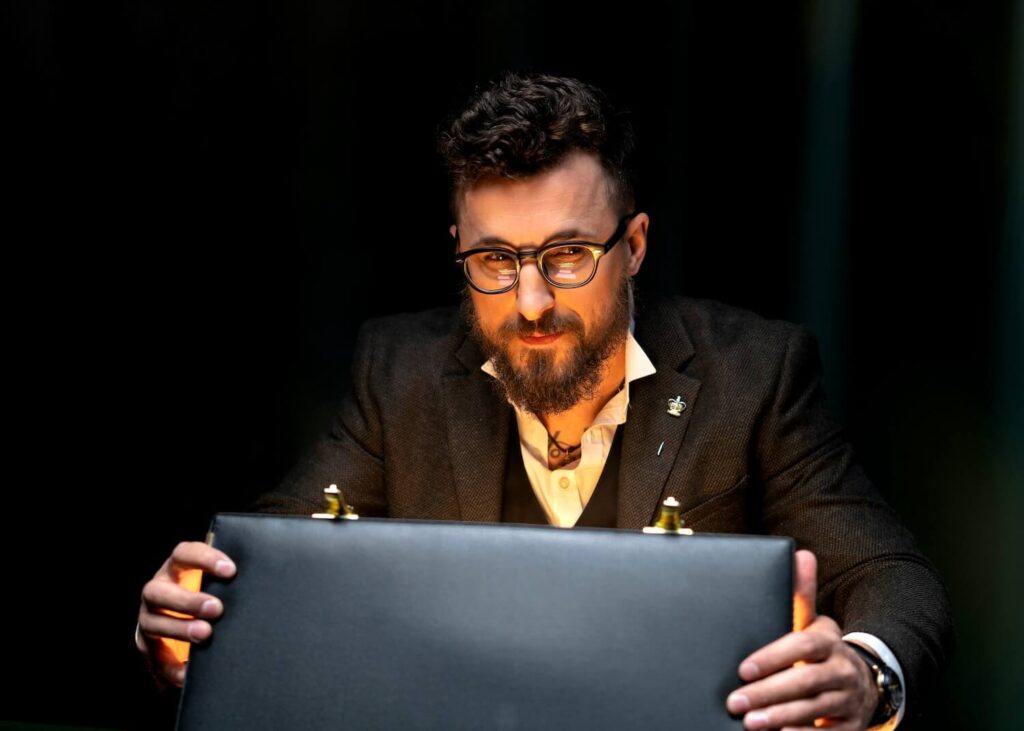 A man opening his briefcase representing what to bring to a job interview