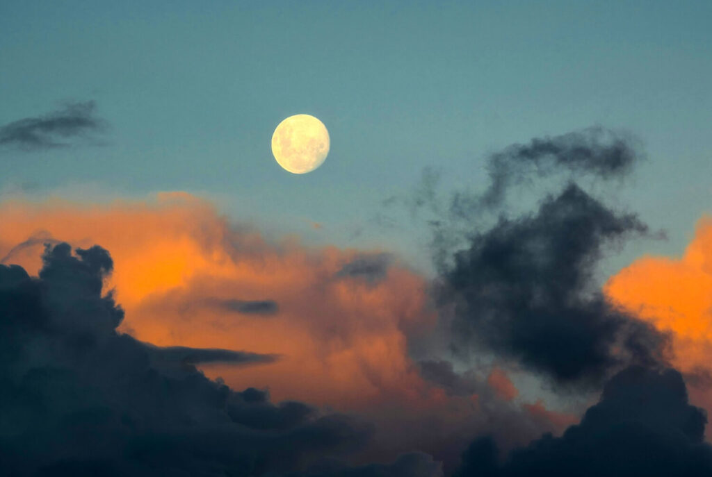 A picture of the moon at sunset representing: What is moonlighting?