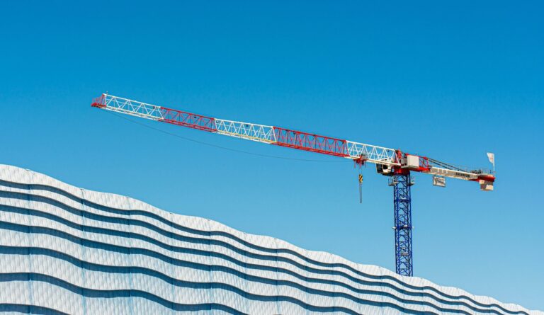 A crane above a building facade representing the construction workforce 2026