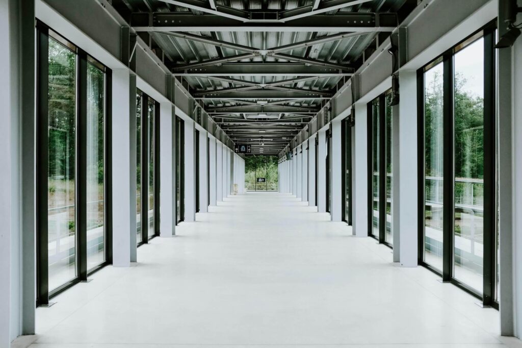 Empty hallway with open doors symbolizing how to conduct an exit interview and the transition of departing employees