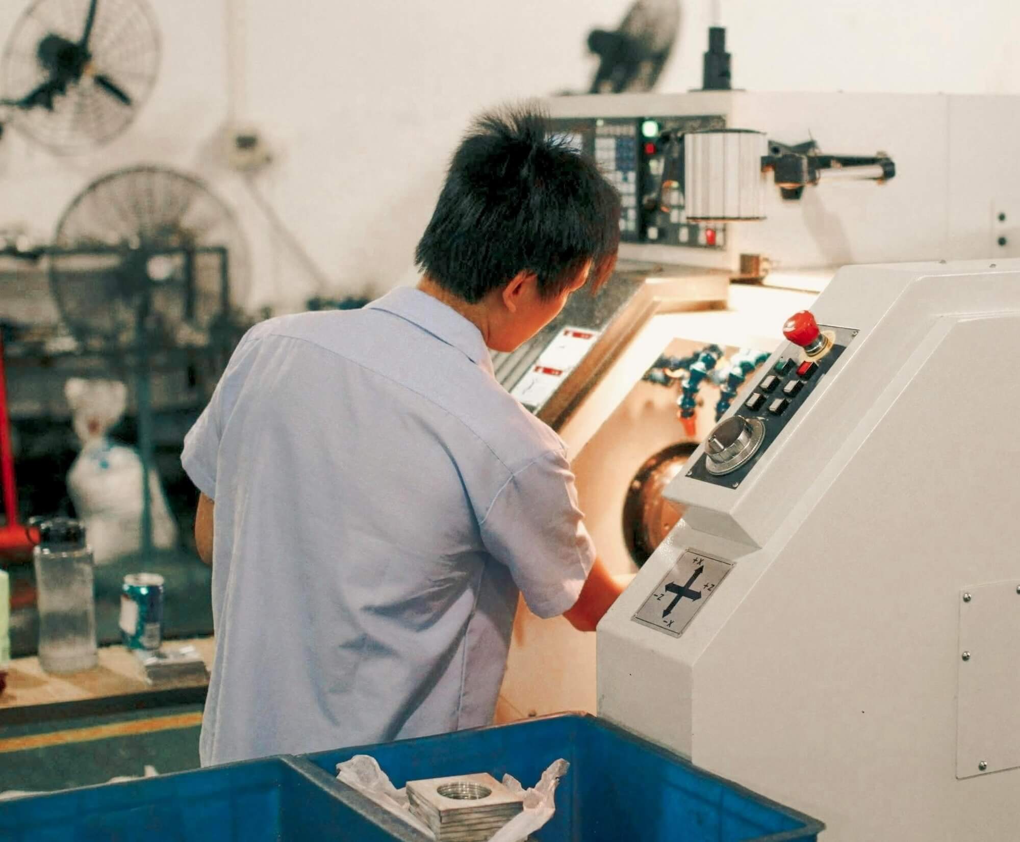 A manufacturing professional operating machinery