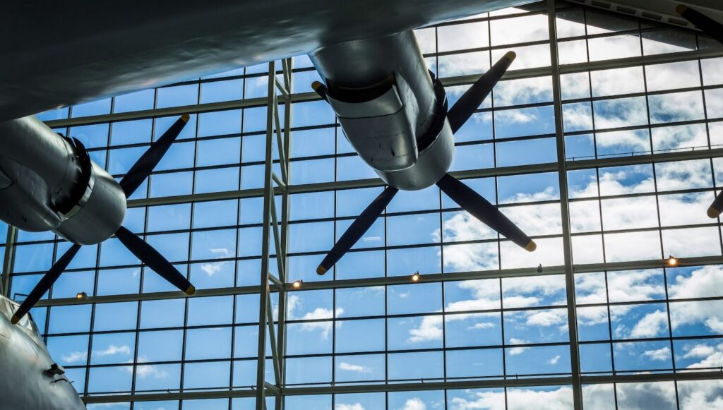 A quad-engine prop plane inside a hangar representing the aerospace and defense conferences in 2027